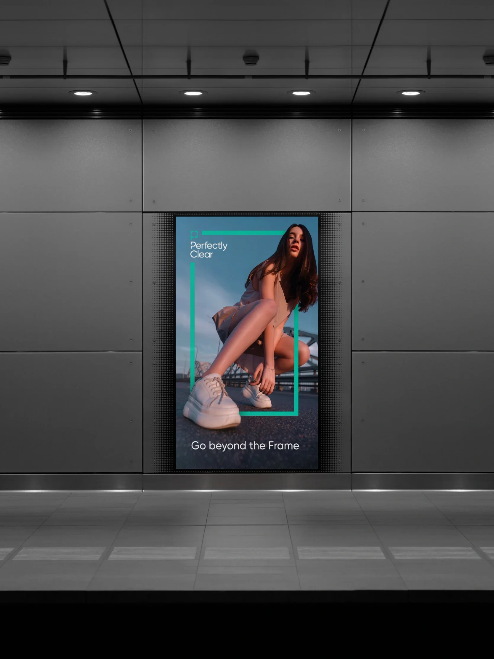 Digital billboard in a subway station displays a woman crouching with the text Perfectly Clear and Go beyond the Frame, highlighting sleek UI.
