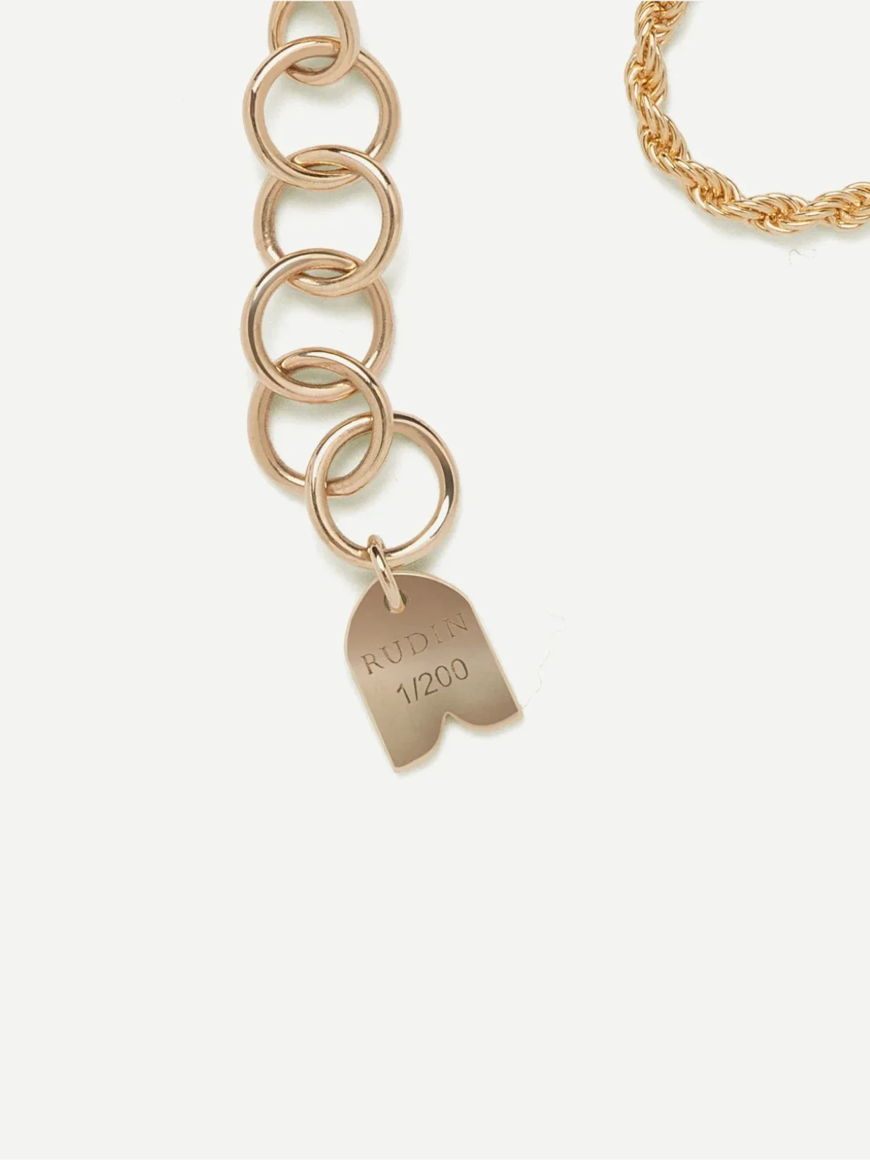 Close-up of Rudin jewellery with engraved tag