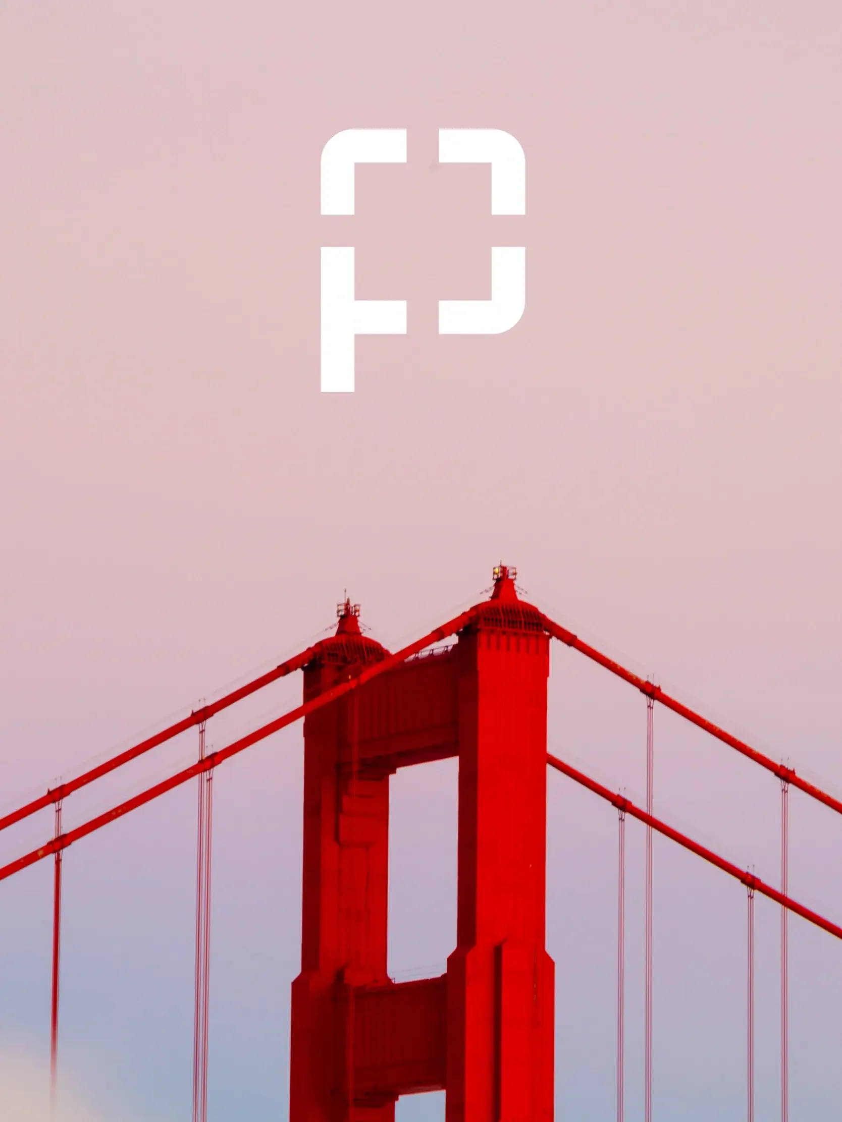 The top of the Golden Gate Bridge against a pink sky, with a white Perfectly Clear logo centered above it for your website UI.