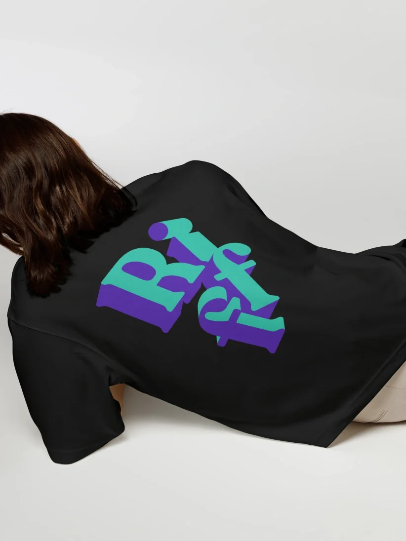 A person lying down in black apparel with large, bold, blue and purple Riff text showcasing unique brand identity on the back.
