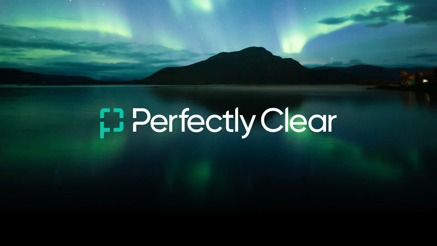 Aurora borealis glows over a mountain and lake at night, with the Perfectly Clear logo centered to highlight its brand identity.