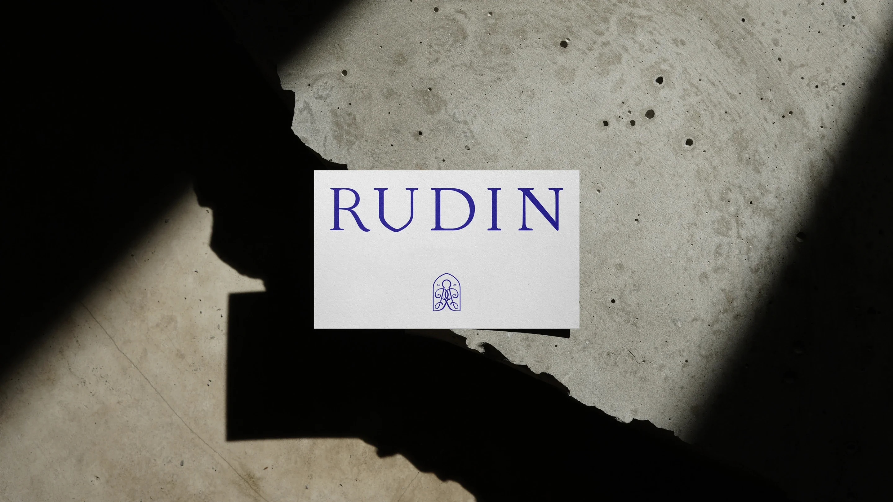 Rudin business card on textured surface