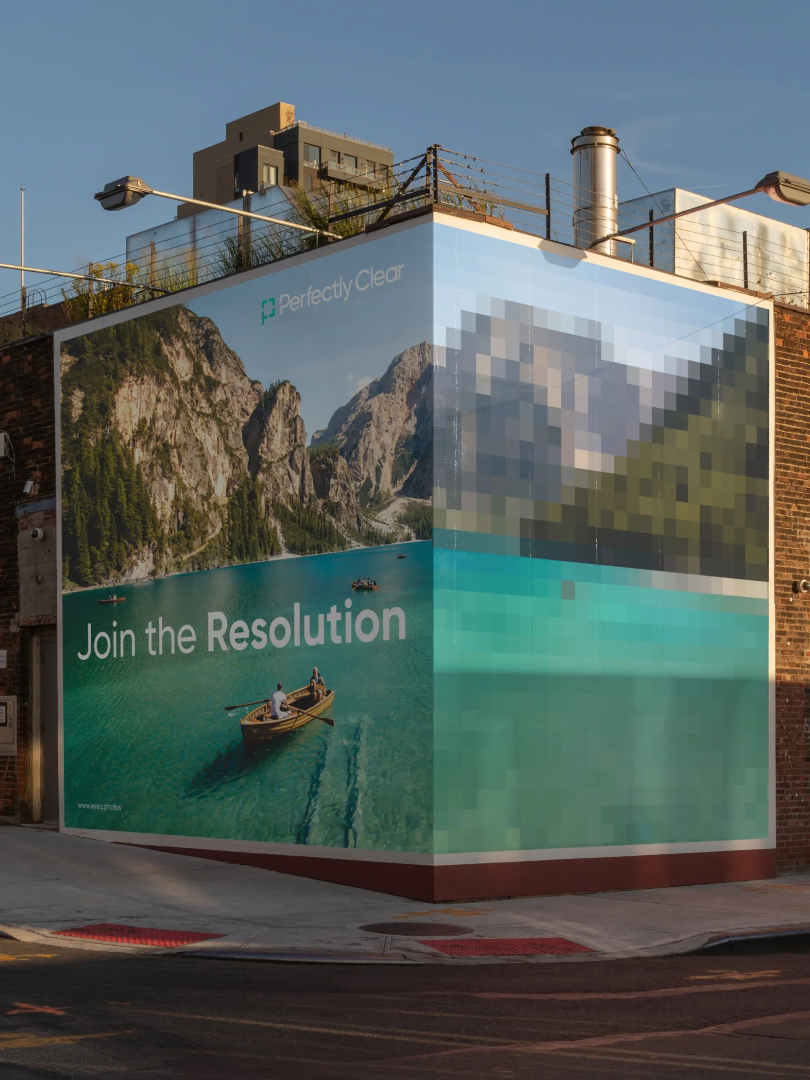 A billboard shows a sharp mountain lake photo beside a pixelated version. Text reads, Join the Resolution—with Perfectly Clear app design.