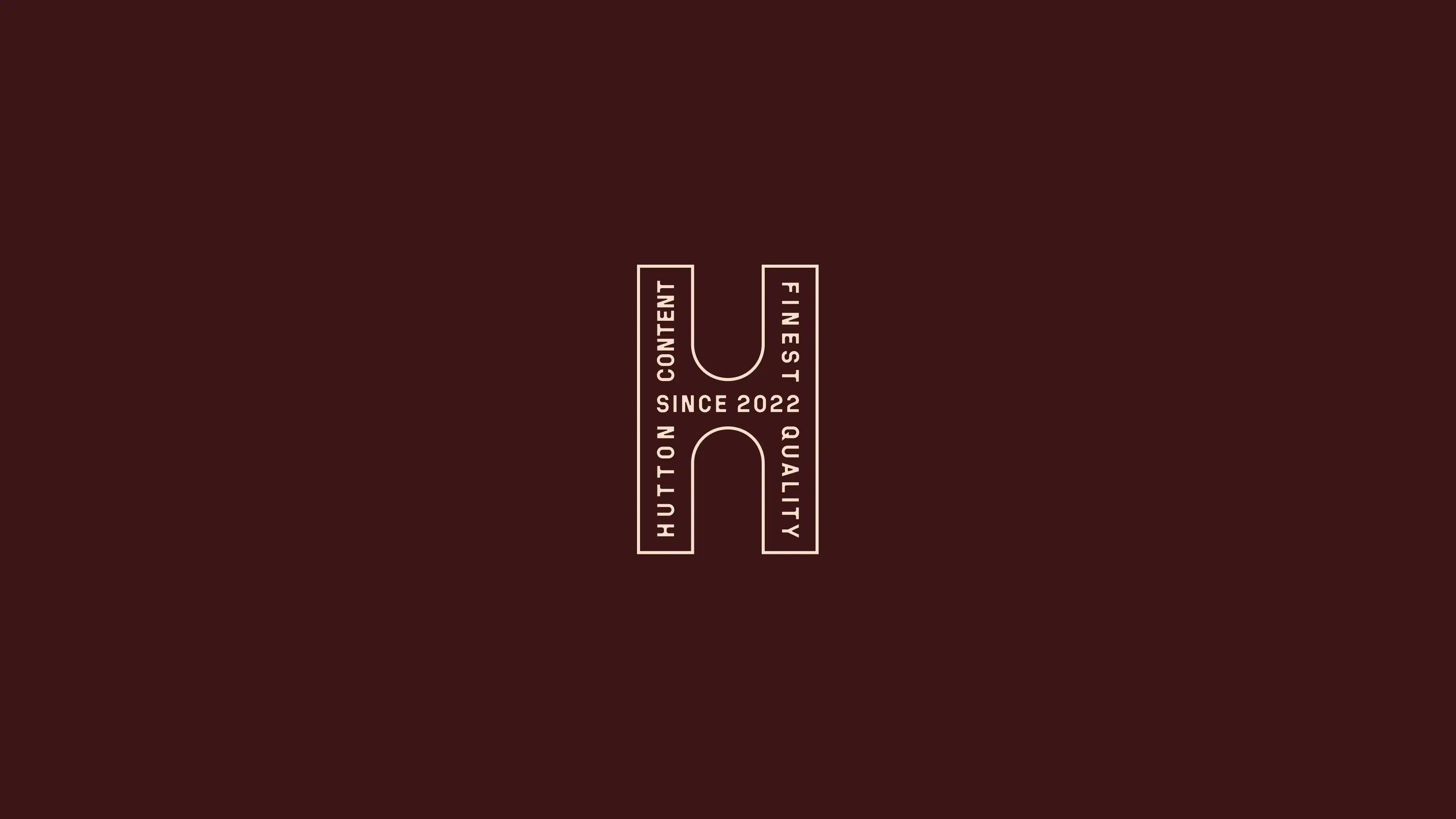 An outlined letter H on burgundy holding the words “Hutton Content”, “Finest Quality” and “Since 2022”, in the manner of a maker’s stamp