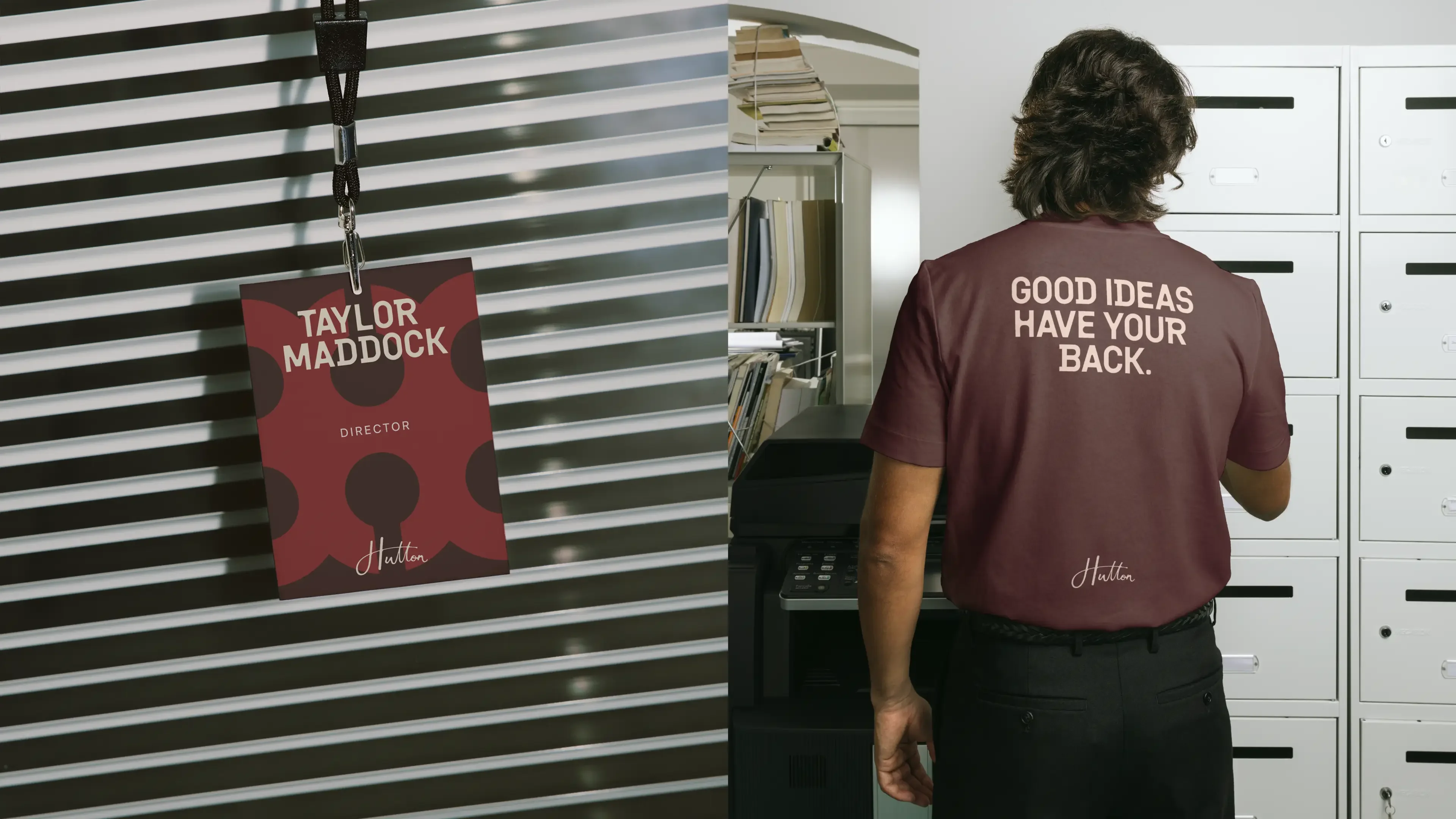 A red and burgundy event pass on a lanyard reading “Taylor Maddock, Director”, beside the back of a burgundy T-shirt printed with “Good ideas have your back.” Both carry the Hutton signature